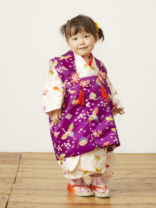 girl standing wearing violet and white