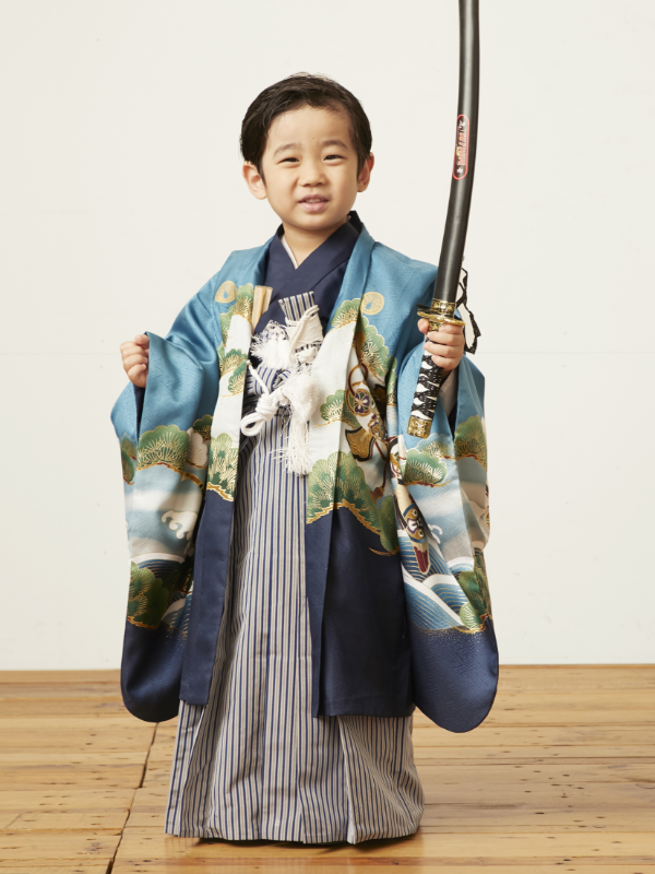 boy standing holding sword