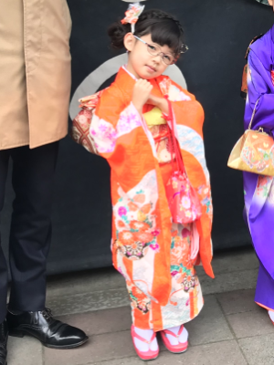 boy standing outdoors wearing blue