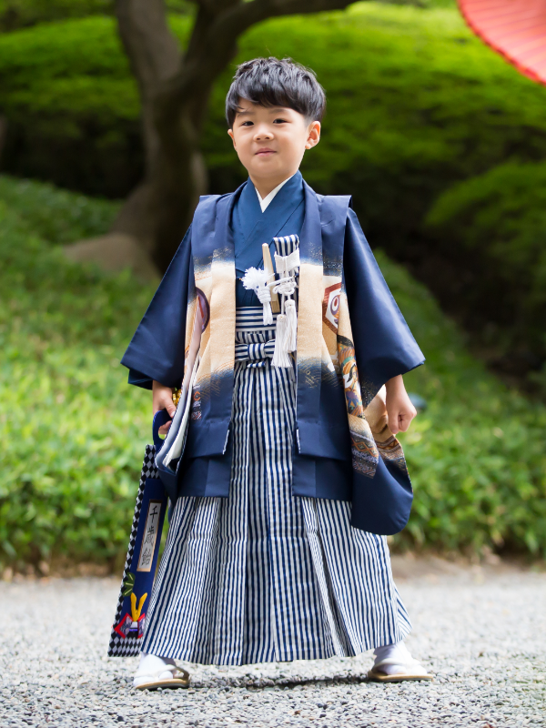 boy standing wearing green holding sword